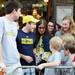 Michigan alumni Andrew Chinsky, of Boston, shows off his cow bell to a group of young SOuth Carolina fans before the start of the Outback Bowl New Year's eve parade in Ybor City, Fla. on Monday night. Melanie Maxwell I AnnArbor.com